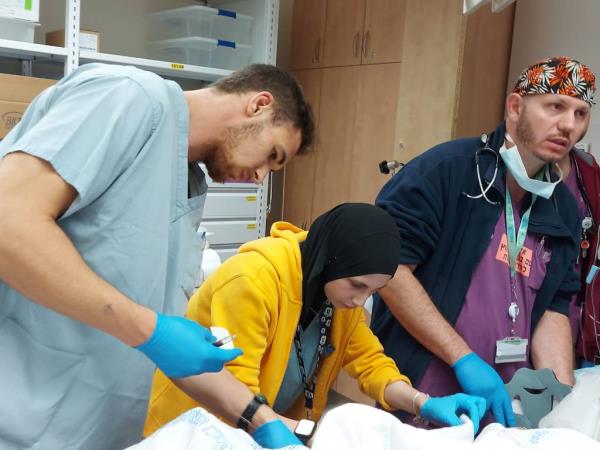 Medical personnel examining a patient at Soroka